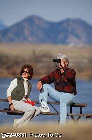 Adult couple over 35 enjoying bird watching